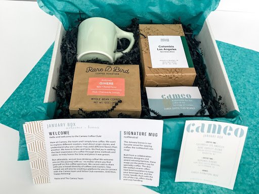 An example of the coffee subscription box, which has one mug, three coffees, and tasting note cards