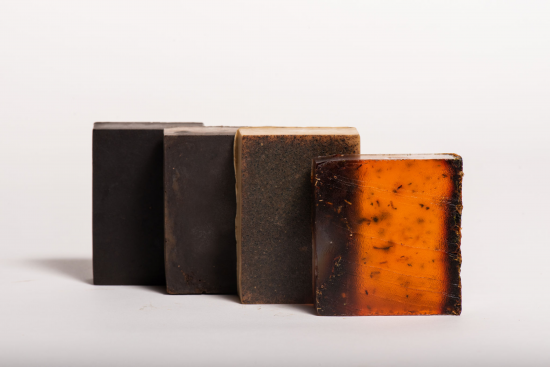 These are multiple soap bars from the product line made of coffee. They are all varying colors of dark and light brown.