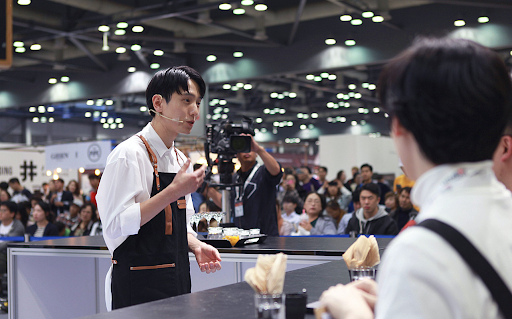 Hyun-young delivers his competition speech at a barista championship.