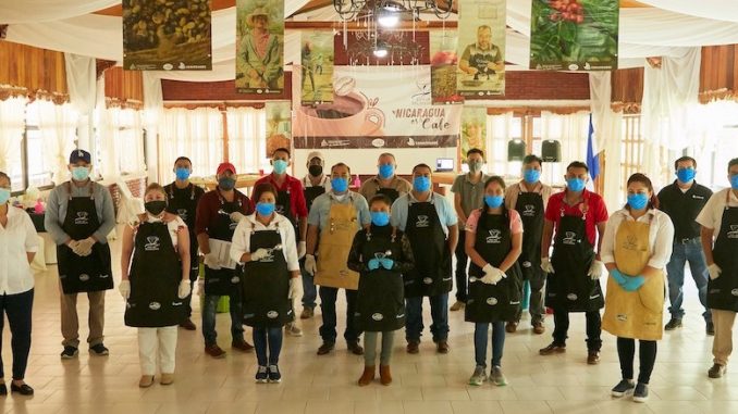 A group of producers and scientists stand together with facemasks on.