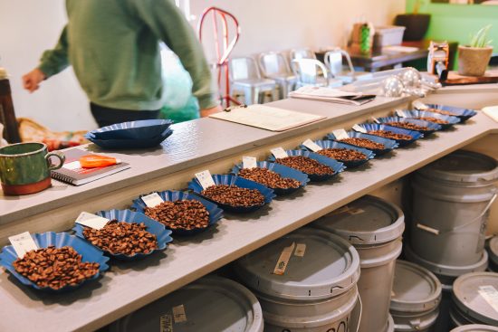 A wide angle shot of roasted coffee samples. They sit in small blue plates.