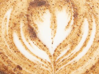 A closeup of latte art with sorghum in it.