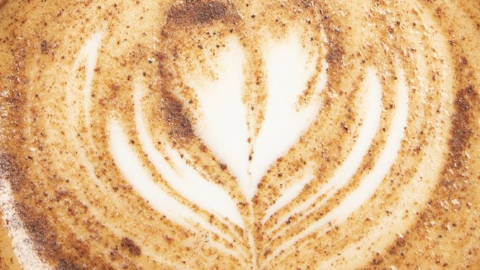 A closeup of latte art with sorghum in it.