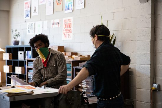 George (lefft) and Daniel (right) stand together going over the details of the print.