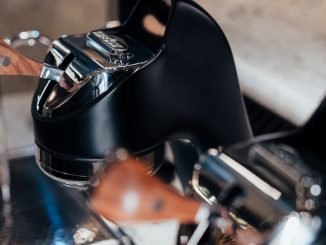 A closeup of a black Modbar countertop espresso machine.