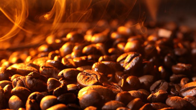 Pile of coffee beans with steam, closeup