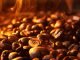Pile of coffee beans with steam, closeup
