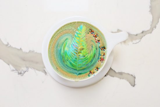 A rainbow rosetta in a latte cup.