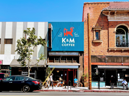 The front of Kindness & Mischief coffee, which is bright blue with a fox painted on top of the logo.