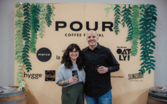 Diana is on the left holding a mug and posing smiling next to co-founder Matt Dudley.