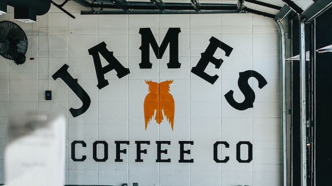 The interior of a coffee shop with James Coffee Company written in big block font