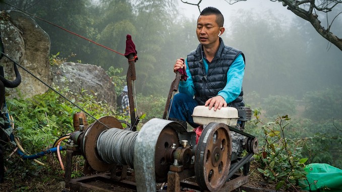 A coffee farmers uses a processing machine in taiwan.