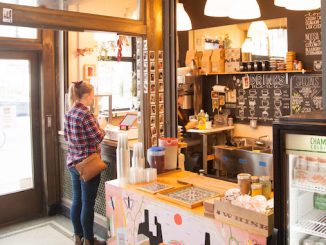 A customer stands inside the adventure cafe waiting to place an order.