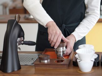 The bottom half of a man tamping with the new april tamper.