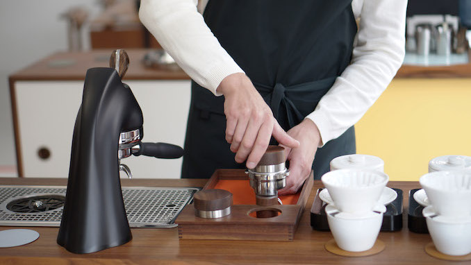 The bottom half of a man tamping with the new april tamper.