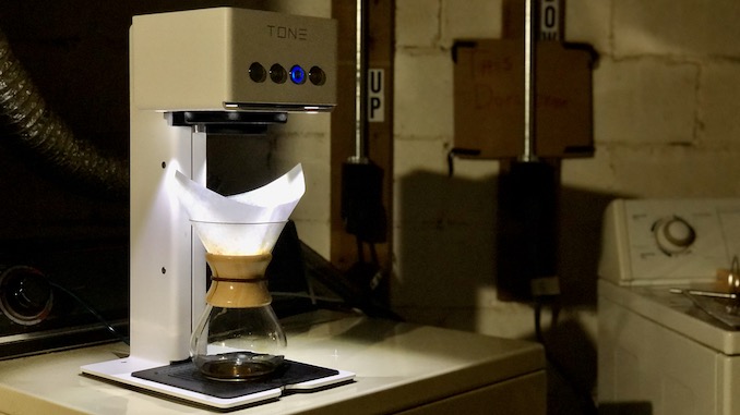 The touch tone brewer in a basement with a chemex underneath it.