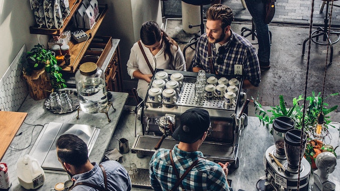 An aerial shot of baristas working at an espresso machine