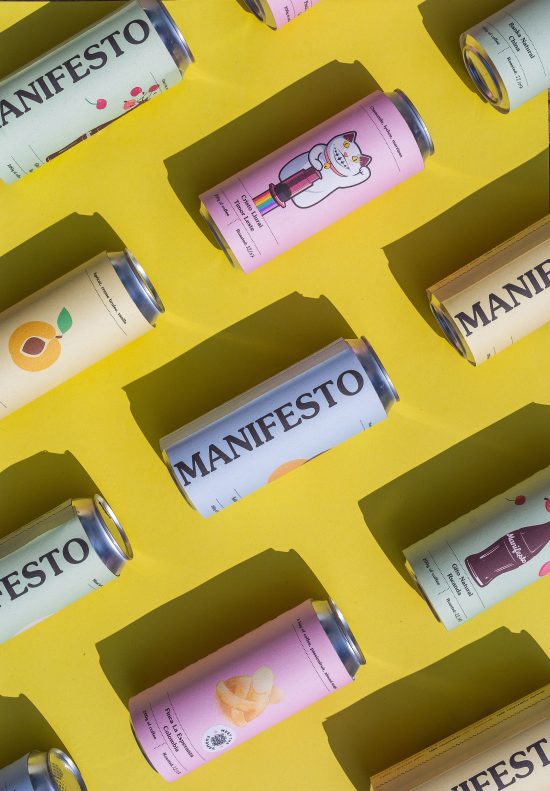 A bright yellow background with a set of pastel colored cans lined up against it. These are filled with coffee.