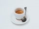 A simple white cup of espresso on a white background.