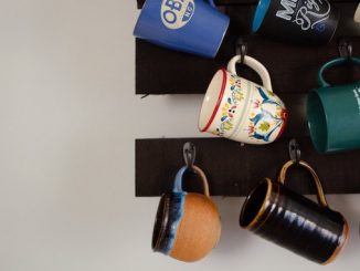 A set of mugs hanging from a ceiling.