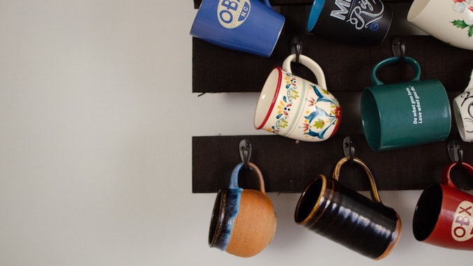 A set of mugs hanging from a ceiling.