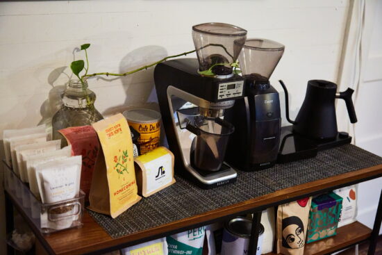 Aireus Robinson's coffee grinders and coffee on a shelf.