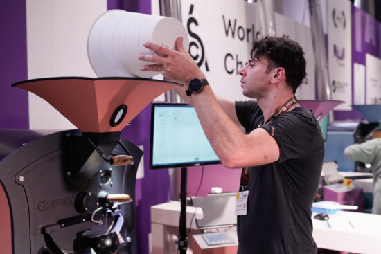 Felix Teiretzbacher filling a hopper at the World Coffee Roasting Championship in Milan, Italy.