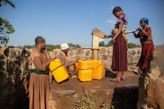 Residents in Jabi Tehnan pump water from a well constructed through Project Waterfall.