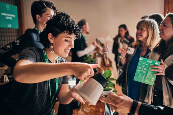 Baristas pouring coffee to attendees at Beanstock Coffee Festival.