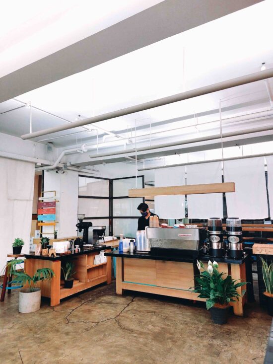 The café space with a barista at the counter at Yardstick Coffee in Manila.