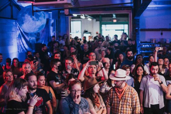 A crowd of people including attendees and competitors at the Barista League Kansas City.