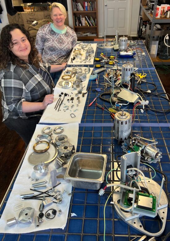 Students at a table with disassembled grinder parts.