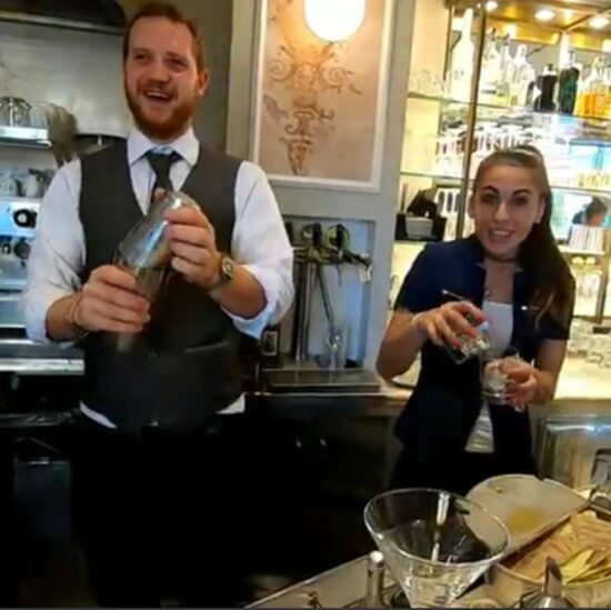 Two baristas preparing shakeratos.