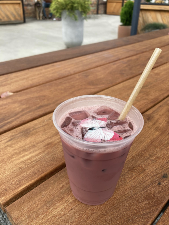 A Summertime Chai Tea Latte seasonal drink in a to-go cup on bench at Summit Coffee in Charlotte, N.C.