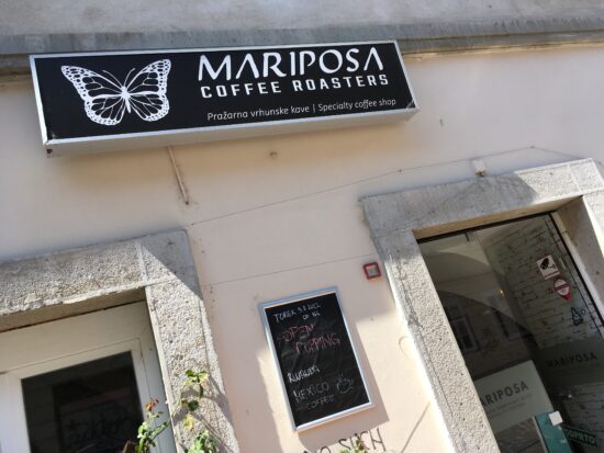 Picture of Cafe Mariposa's entrance with a butterfly sign above it.