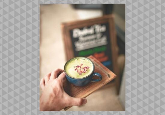 A White Rose drink served in a ceramic mug on a wooden plate 