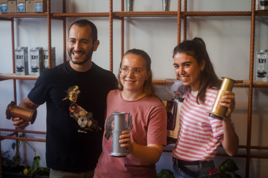 Winners of the competition pose with their bronze, silver and gold medals: AeroPresses in variegated colors. 