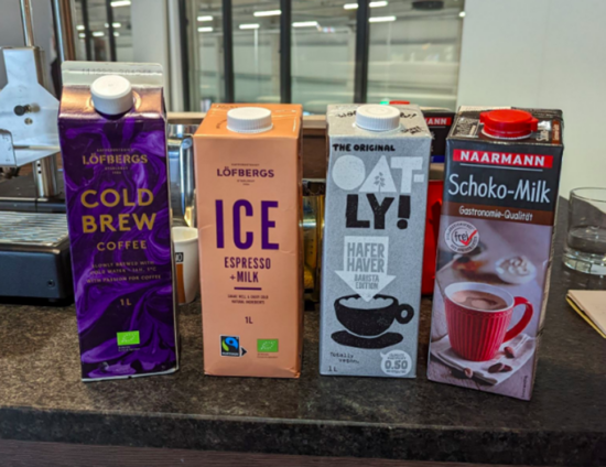 Four one-liter liquid cartons used for testing out the steam wands. Lofbergs cold brew coffee; Lofbergs Iced espresso and milk; oatly barista edition milk; and Naarman chocolate milk.