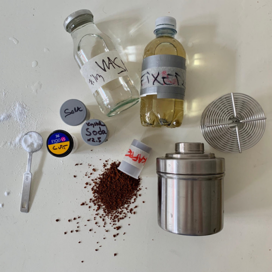 Los ingredientes para la elaboración del cafenol: sal, soda, café, fijador y detergente. Hay un recipiente de metal con una tapa de rosca y posavasos que colocan el papel de aluminio y le permiten sacarlo nuevamente si está dañado.