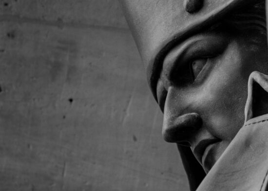 Closeup of Napoleon statue showing only his determined face and part of his tricorner hat and tall coat collar.