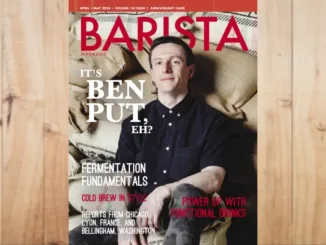 Feature image of the April + May 2023 issue of Barista Magazine. The magazine on a wooden background.