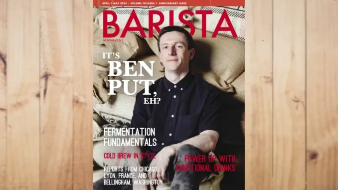 Feature image of the April + May 2023 issue of Barista Magazine. The magazine on a wooden background.