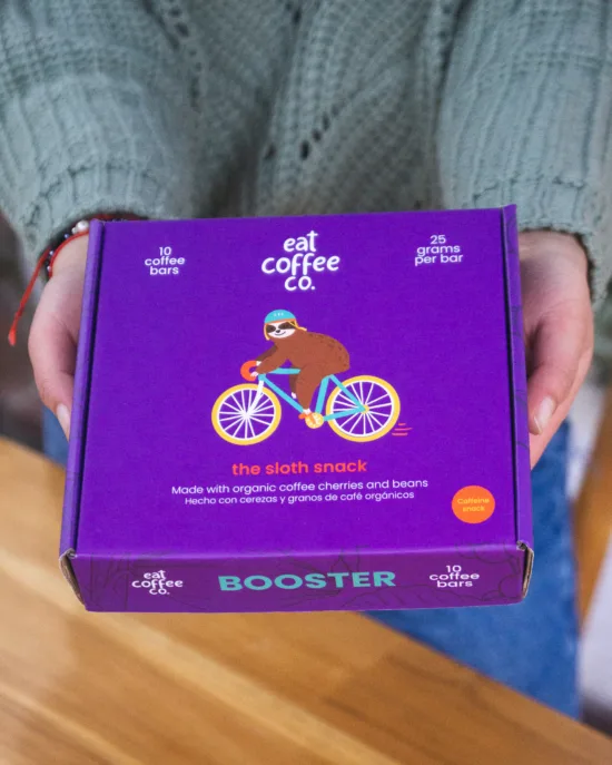 Eat Coffee Co's sloth snack box of ten bars. It's blue with a drawing of a sloth riding a blue and yellow bike and wearing a helmet. 