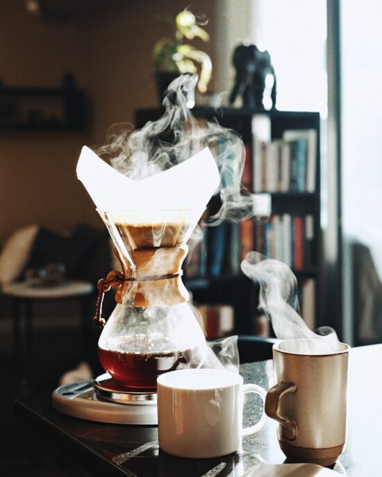 The Chemex is shaped like an hourglass with a flared conical top and rounded bottom. It doubles as a serving vessel, so a pitcher underneath is not needed. It has a wood handle around the middle of the hourglass shape.