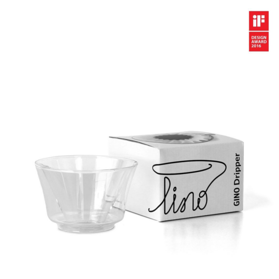 The Gino is clear glass and conical, has a flat bottom and is double walled, similar to some clear glass espresso cups. Next to it is the small white box, labeled Gindo Dripper on the side, with the product title in a stylized script. The image also contains a small red label on the top right that reads iF design award 2016.