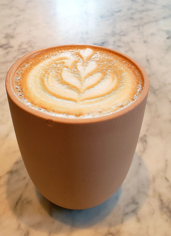 Ruby red mocha comes in a pink ceramic cup with a rosetta latte art.