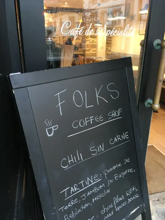 Folks sign with the name, "Coffee shop" and specials: chili sin carne, tartine with apples and jam.