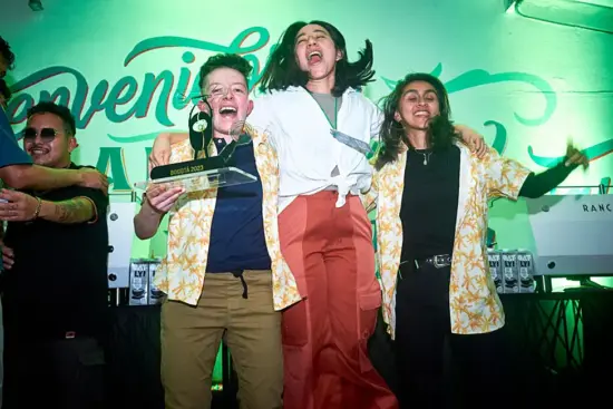 The trio jumps up in the air with theor trophy: Carolina on left, Ivette in the middle and Lorena on the right.