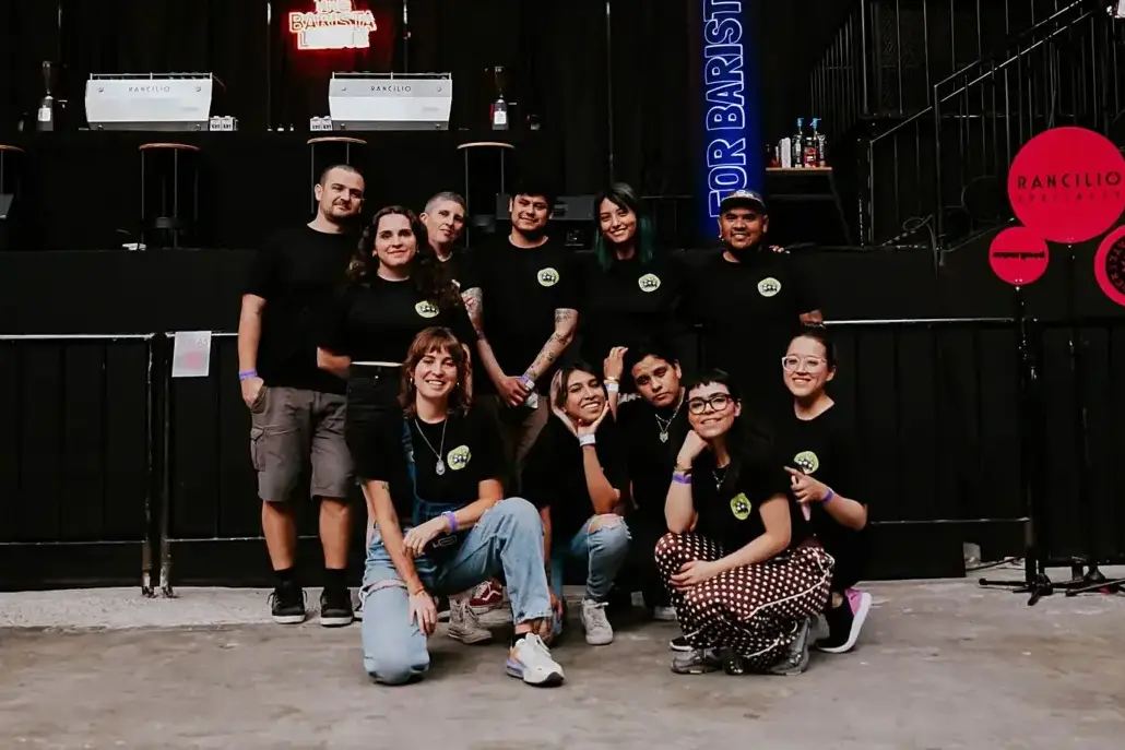 Ten volunteers pose together for a photo, all in their black event t shirts.