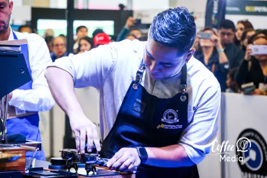 Edwin Tascon tamps coffee in a competition setting.